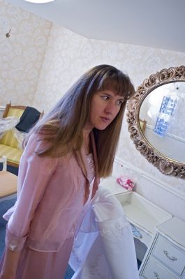 Инна в комнате невесты. Держит хвост от платья.
