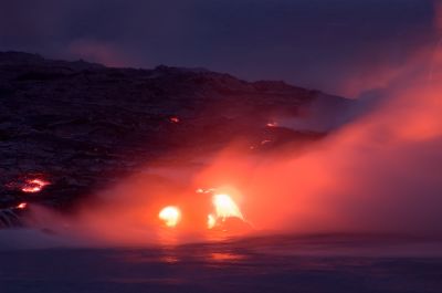 Lava meets ocean at nighttime
